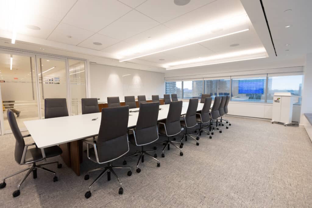 Modern LGRA boardroom with large conference table, ergonomic chairs, and panoramic city views