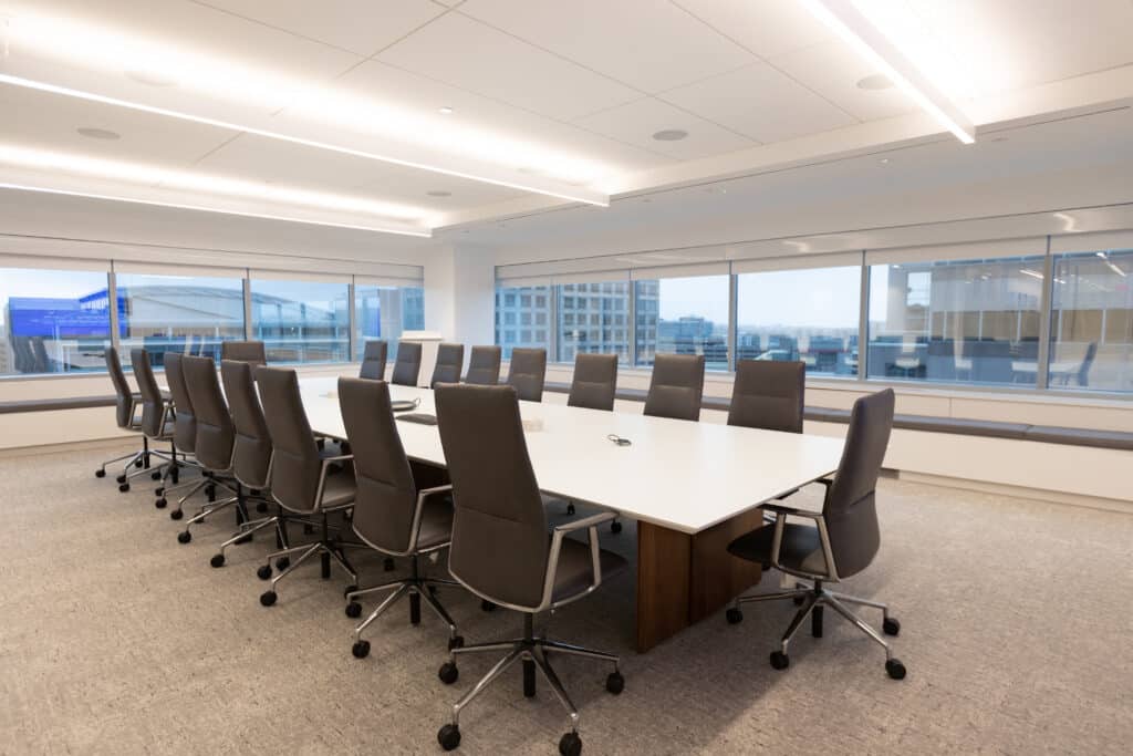 Spacious LGRA conference room with modern boardroom seating and city skyline views through large windows