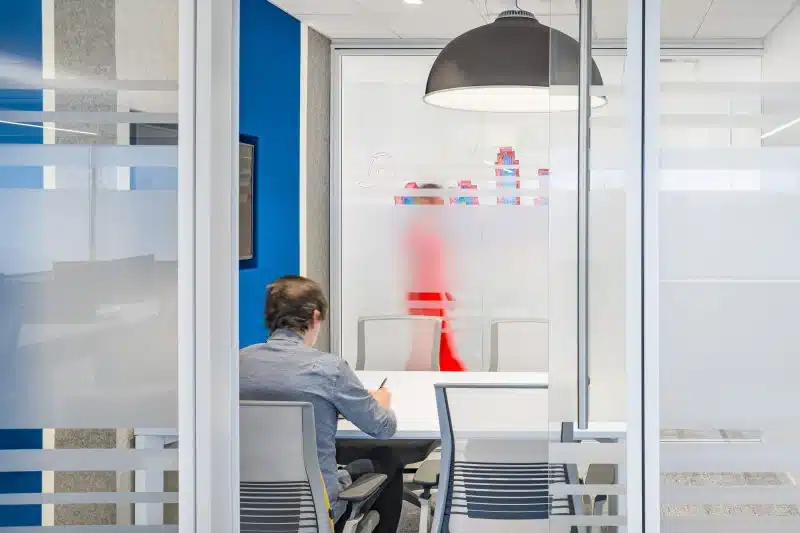 Interior shot of Banner Life employee from behind taking notes